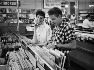 ca. 1959, Los Angeles, California, USA --- Rockabilly singer Eddie Cochran and his fiancee, songwriter Sharon Sheeley, shop for records in a Los Angeles music store in the late 1950s. --- Image by © Douglas Kirkland/CORBIS